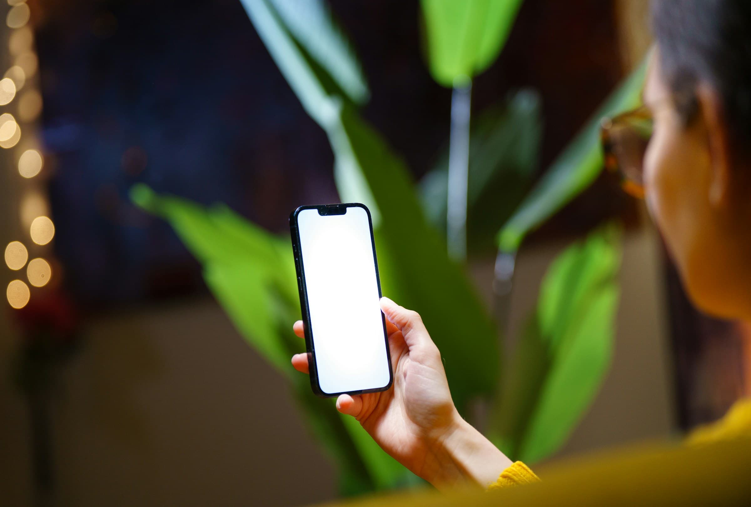 A person holding a smartphone with its screen on